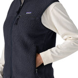 Side of woman wearing the Patagonia women's retro pile fleece vest gilet in sunken blue.