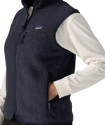 Side of woman wearing the Patagonia women's retro pile fleece vest gilet in sunken blue.