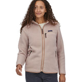 A woman with long curly hair wearing a  Patagonia Women's Retro Pile Hoody Shroom Taupe