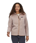 A woman with long curly hair wearing a  Patagonia Women's Retro Pile Hoody Shroom Taupe