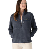 A woman with dark long hair wearing a Patagonia Women's Retro Pile Marsupial jacket in a grey colour