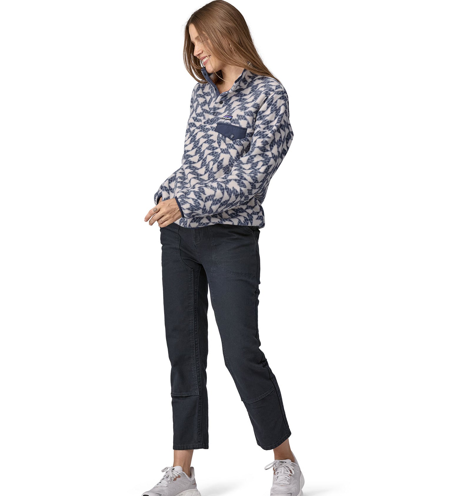 A woman wearing a Patagonia Women's Synch Snap-T pull over Synched Flight Small