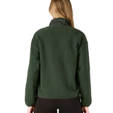 Back of woman wearing the Patagonia women's synchilla fleece jacket in dark green.
