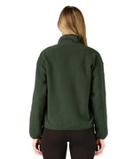 Back of woman wearing the Patagonia women's synchilla fleece jacket in dark green.