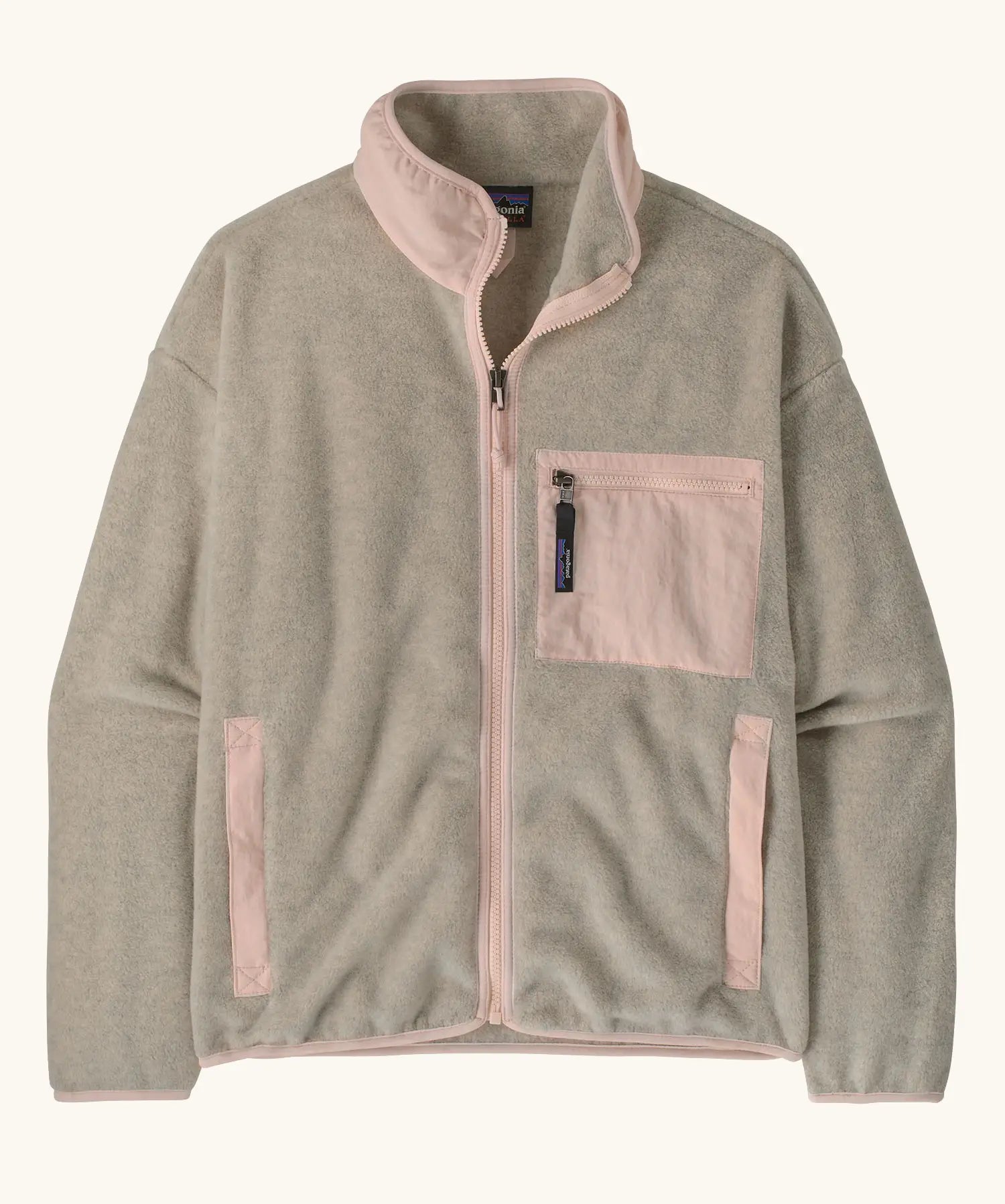 Patagonia women's synchilla fleece jacket in oatmeal heather and pink frost. Full zip jacket with zippered chest pocket and handwarmer pockets.
