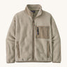 The Patagonia Women's Synchilla® Fleece Jacket in Oatmeal Heather / Seabird Grey is a pale oatmeal full zip fleece jacket with darker beige contrasting binding, patch pocket and collar. Made from Synchilla® 100% recycled fleece.