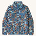 Patagonia women's blue synchilla fleece with a retro design on a cream background.