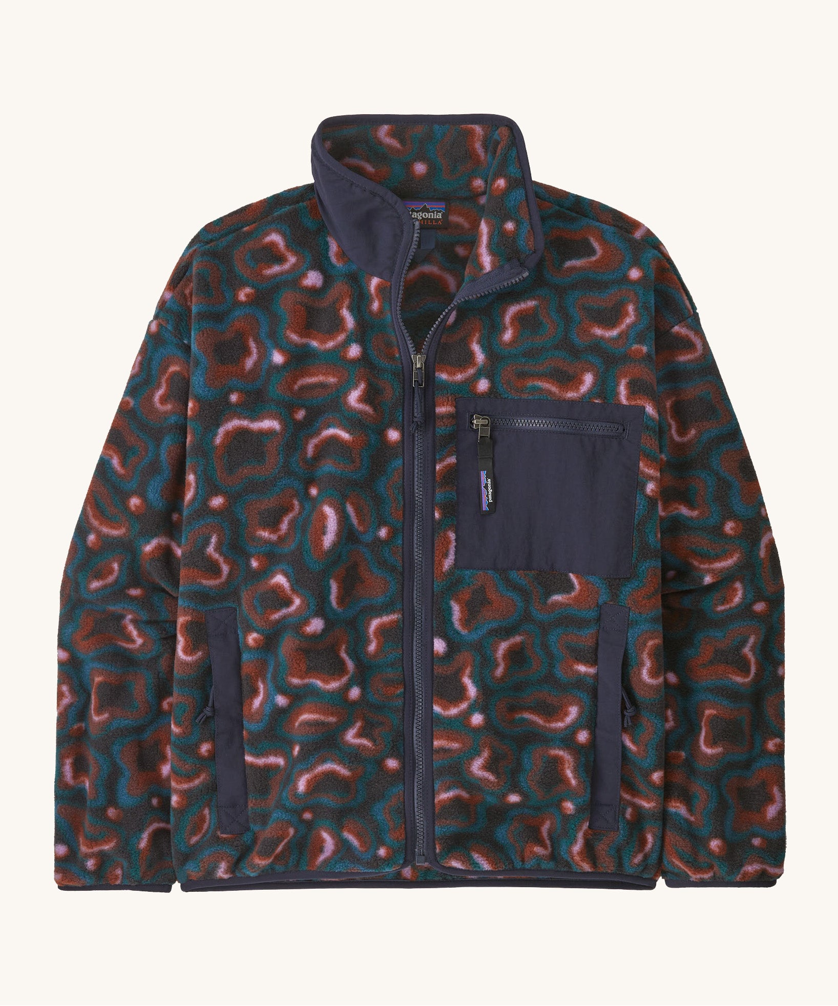The Patagonia Women's Synchilla® Fleece Jacket in spirea/dried vanilla is a patterned full zip fleece jacket with darker blue contrasting binding  patch pocket and collar. 