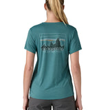 patagonia women's capilene top in a turquoise colour with logo design worn by a woman back detail