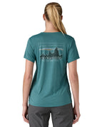 patagonia women's capilene top in a turquoise colour with logo design worn by a woman back detail