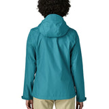 Back of a women wearing the Patagonia women's waterproof torrentshell 3L rain jacket in glacial blue.