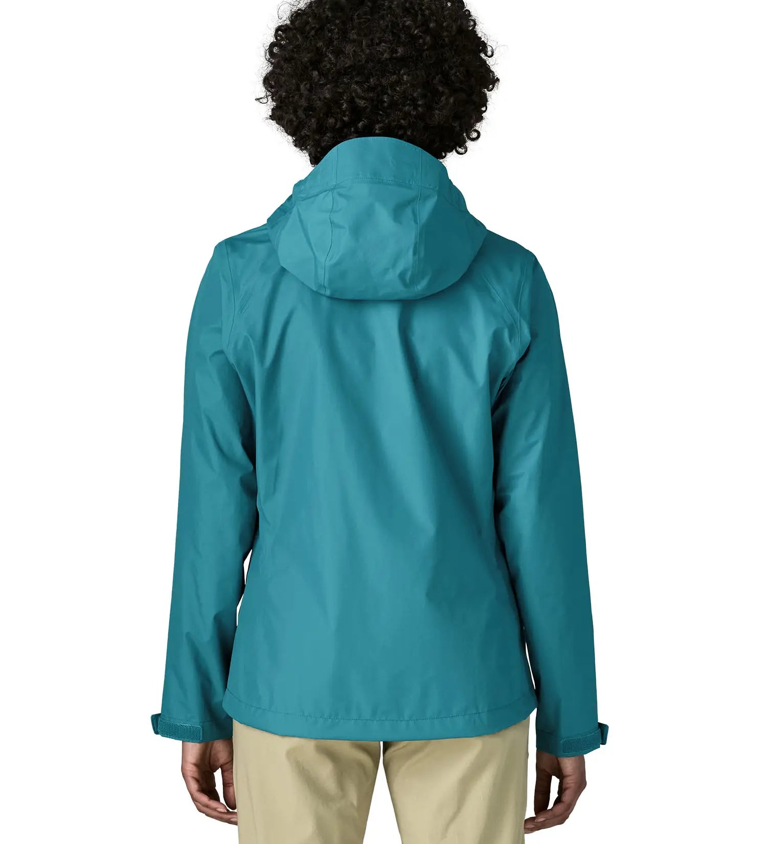 Back of a women wearing the Patagonia women's waterproof torrentshell 3L rain jacket in glacial blue.