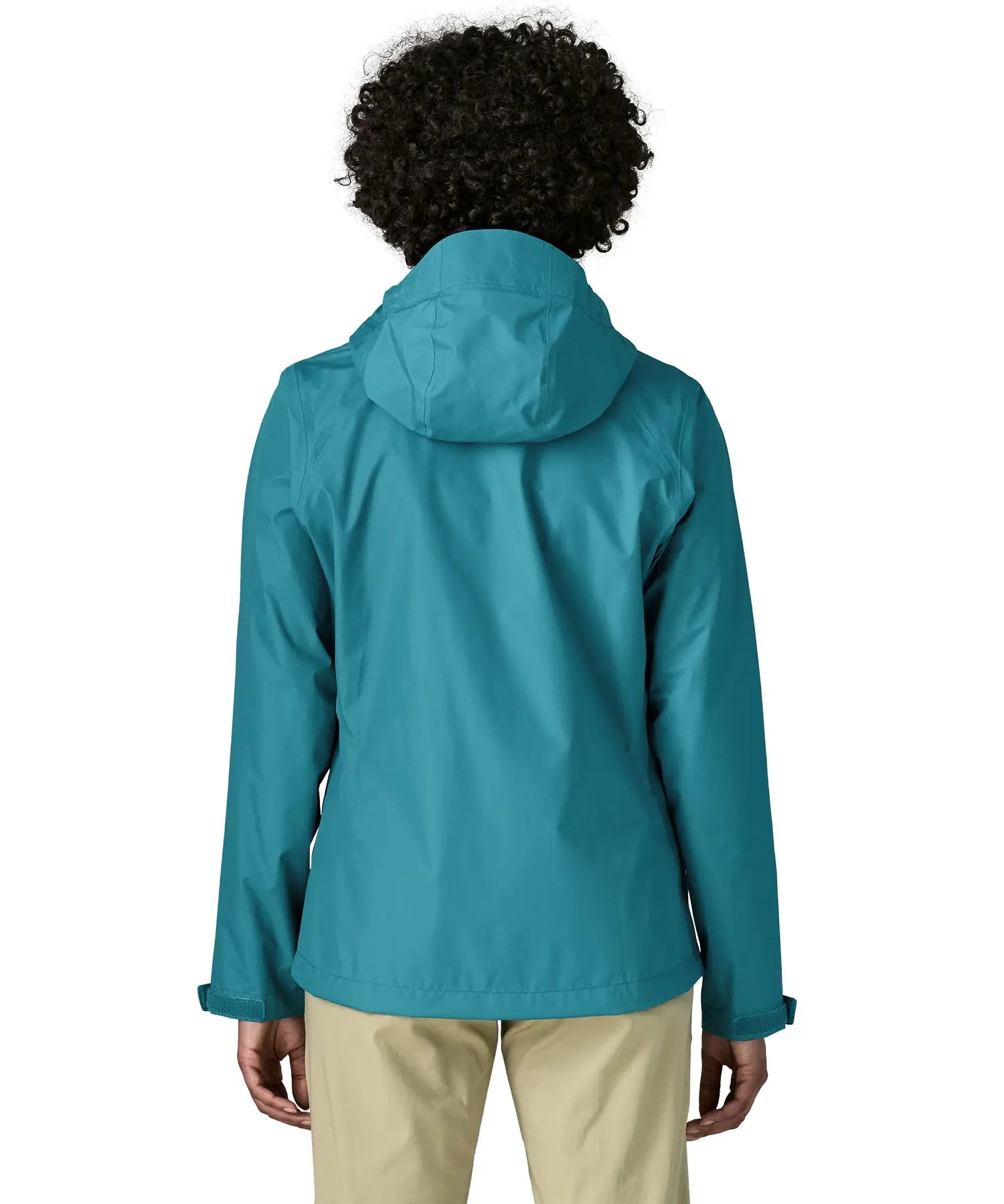 Back of a women wearing the Patagonia women's waterproof torrentshell 3L rain jacket in glacial blue.