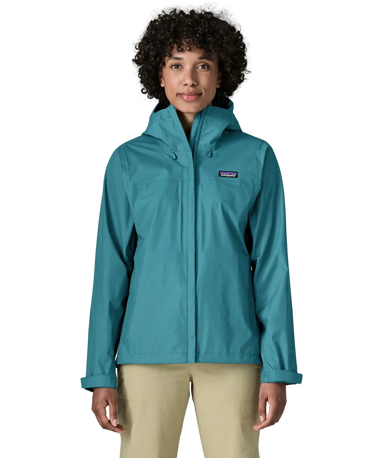 Woman wearing the Patagonia women's waterproof torrentshell 3L rain jacket in glacial blue with the front zip fully closed.