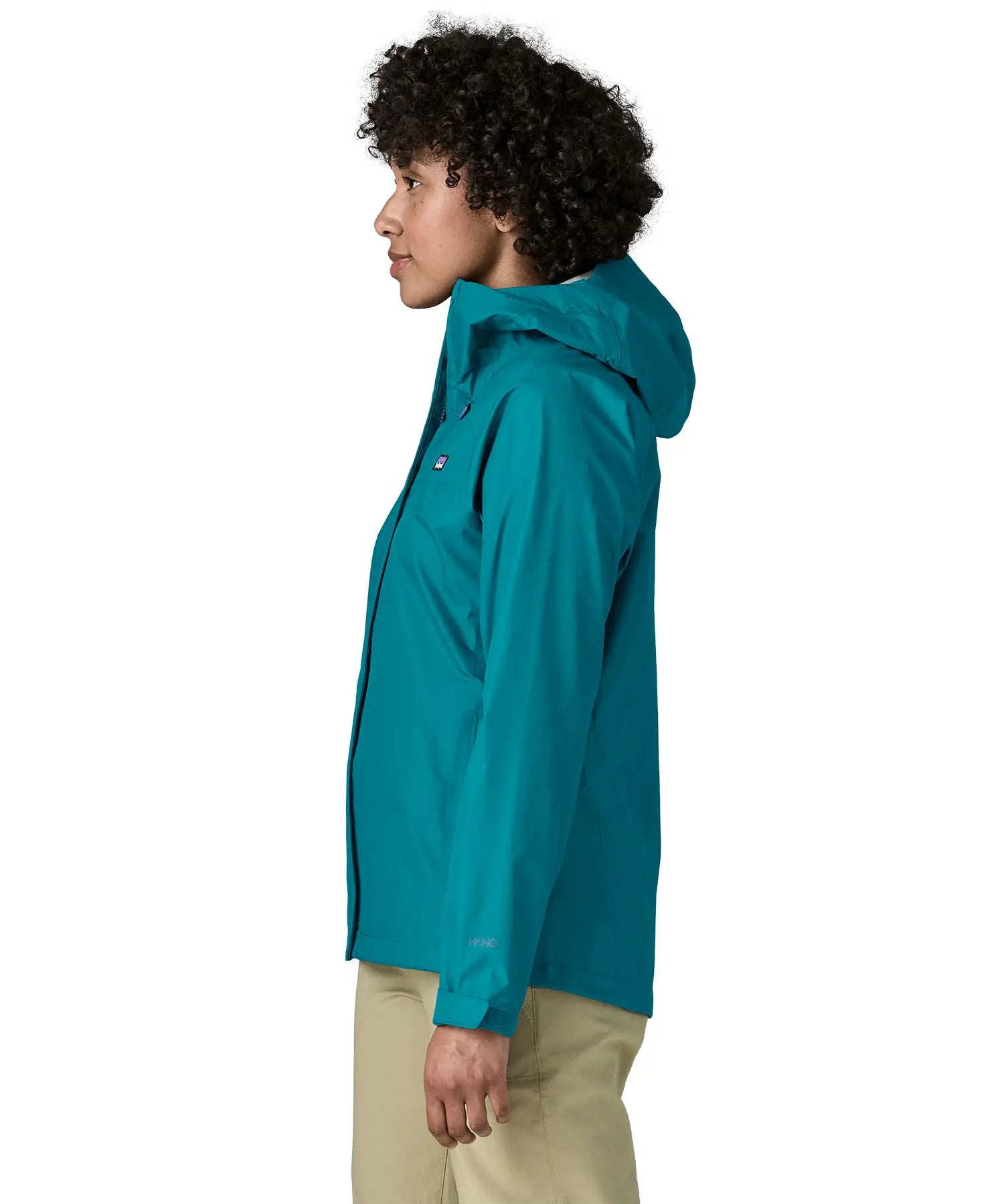 Side of a women wearing the Patagonia women's waterproof torrentshell 3L rain jacket in glacial blue.