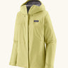 Patagonia women's waterproof torrentshell 3L rain jacket in light vellum green with adjustable hood, zippered handwarmer pockets.