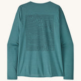 Patagonia women's long sleeve capilene top in turquoise mountain outline design on a cream background.