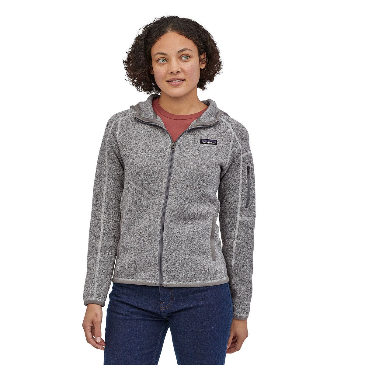 Woman stood on a white background wearing the Patagonia birch white better sweater hoody 