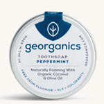 A tin of the peppermint Georganics toothsoap on a cream background