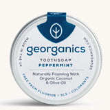 A tin of the peppermint Georganics toothsoap on a cream background