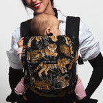 An adult carrying a baby in the Love Radius PhysioCarrier in Tiger.