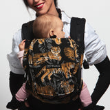 An adult carrying a baby in the Love Radius PhysioCarrier in Tiger.