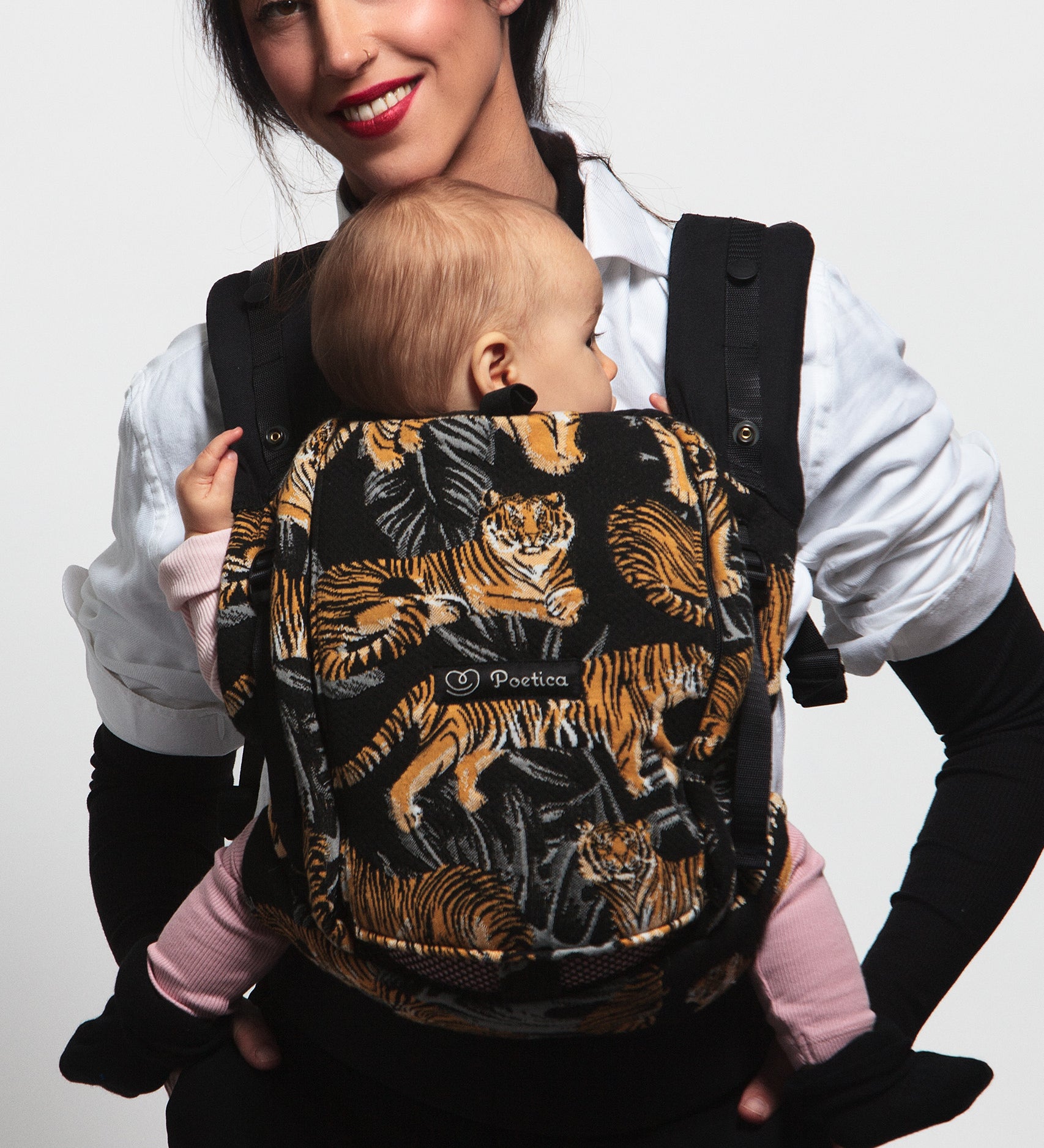 An adult carrying a baby in the Love Radius PhysioCarrier in Tiger.