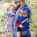An adult carrying a baby in the Love Radius PhysioCarrier in Elephant.