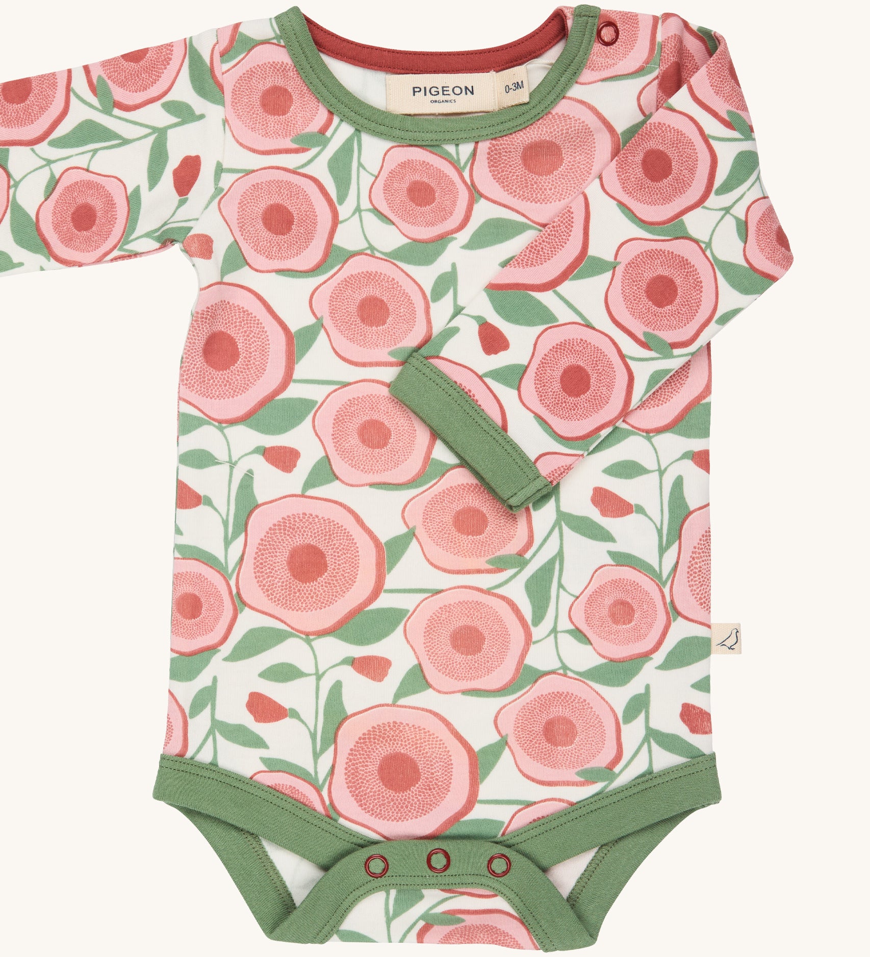 Pigeon Organics large floral body - GOTS organic cotton baby body in a light neutral colour with a pale green trim, long sleeves and popper fasteners at the crotch for easy fitting. Features multiple prints of a pink  flower and green leaves