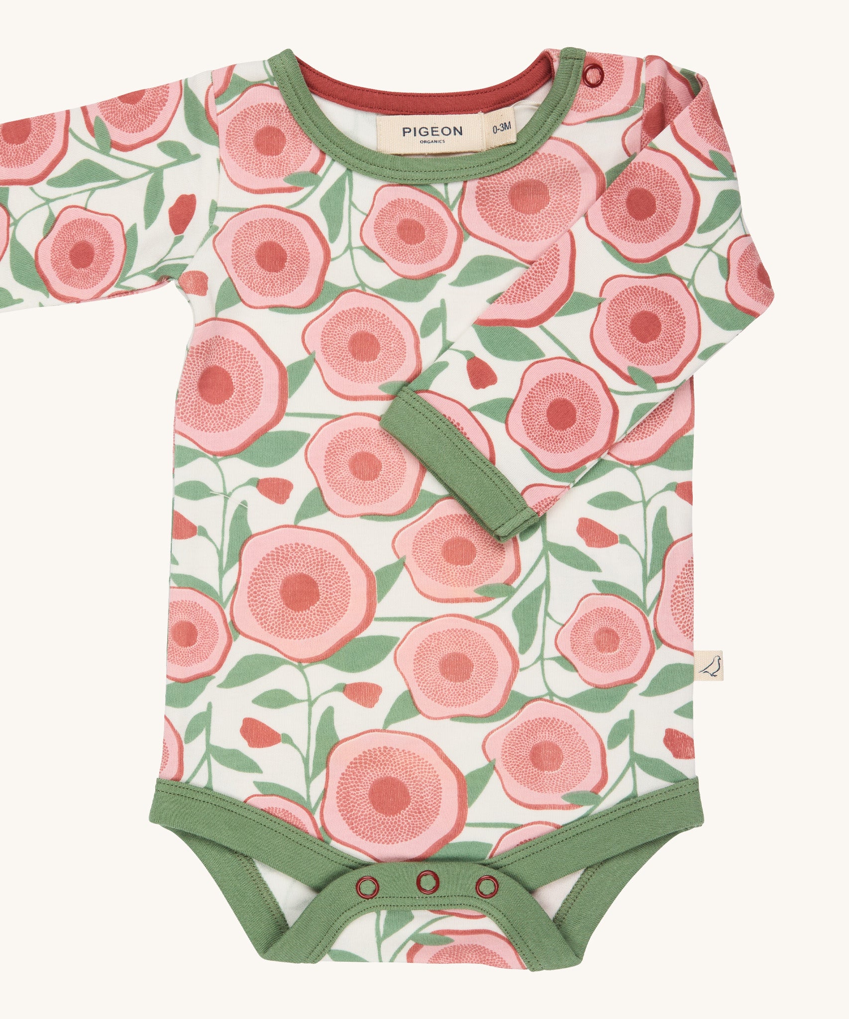 Pigeon Organics large floral body - GOTS organic cotton baby body in a light neutral colour with a pale green trim, long sleeves and popper fasteners at the crotch for easy fitting. Features multiple prints of a pink  flower and green leaves