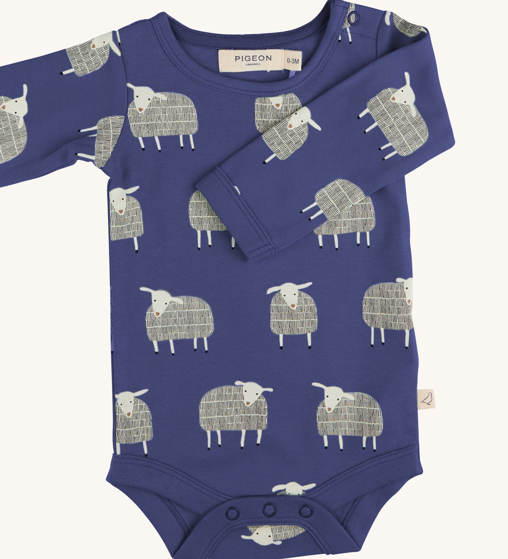 Pigeon Organics sheep body - GOTS organic cotton baby body in a navy blue colour, long sleeves and popper fasteners at the crotch for easy fitting. Features multiple prints of a playful standing white sheep 