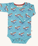 Pigeon Organics Cycling fox body - GOTS organic cotton turquoise baby body with long sleeves and popper fasteners at the crotch. Features multiple prints of a fox riding a blue bike.