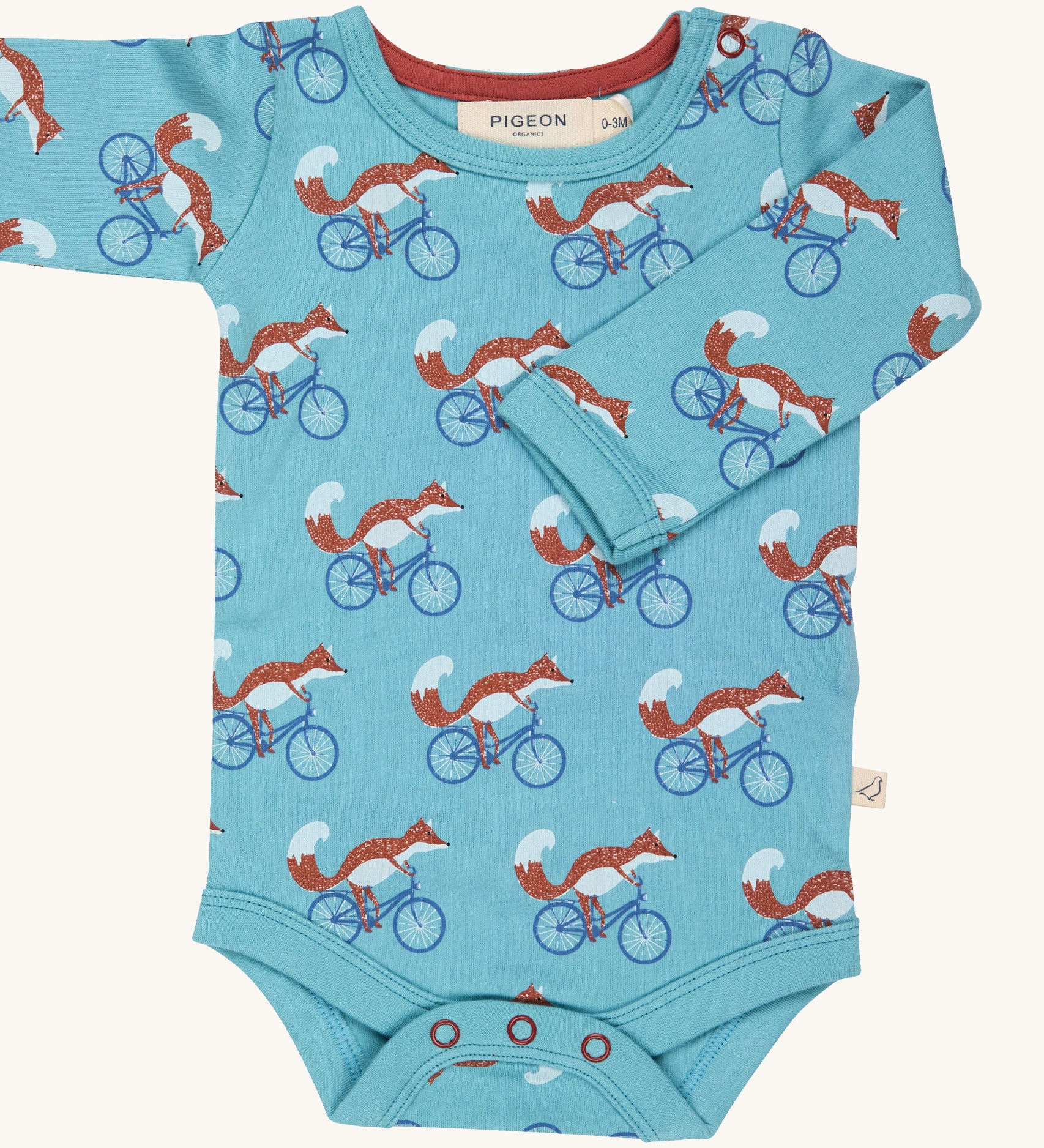 Pigeon Organics Cycling fox body - GOTS organic cotton turquoise baby body with long sleeves and popper fasteners at the crotch. Features multiple prints of a fox riding a blue bike.