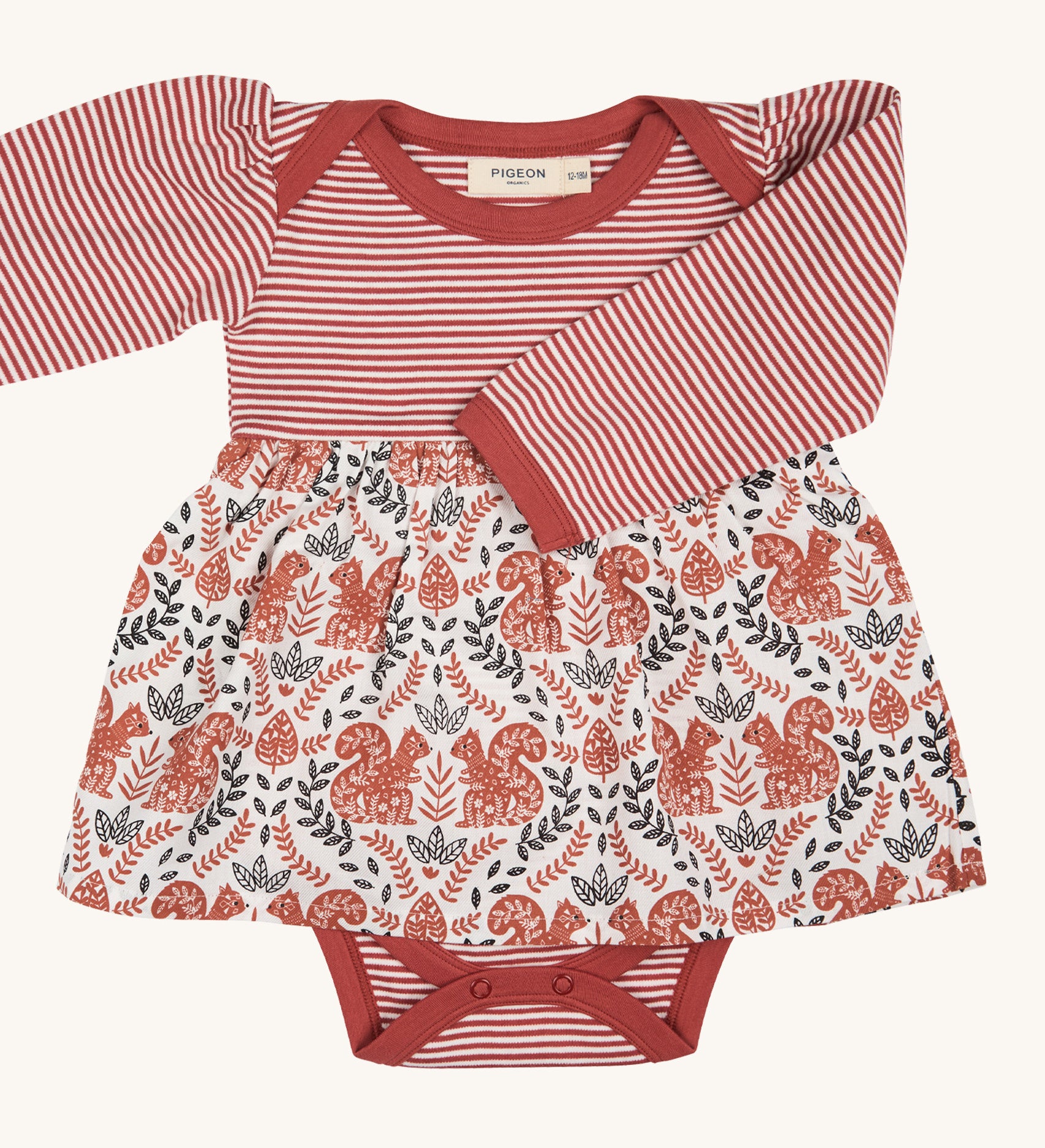Pigeon Organics squirrel baby dress. A pale rust striped top and printed woven skirt on 100% GOTS organic cotton fabric. Features poppers at the crotch for easy changing.
