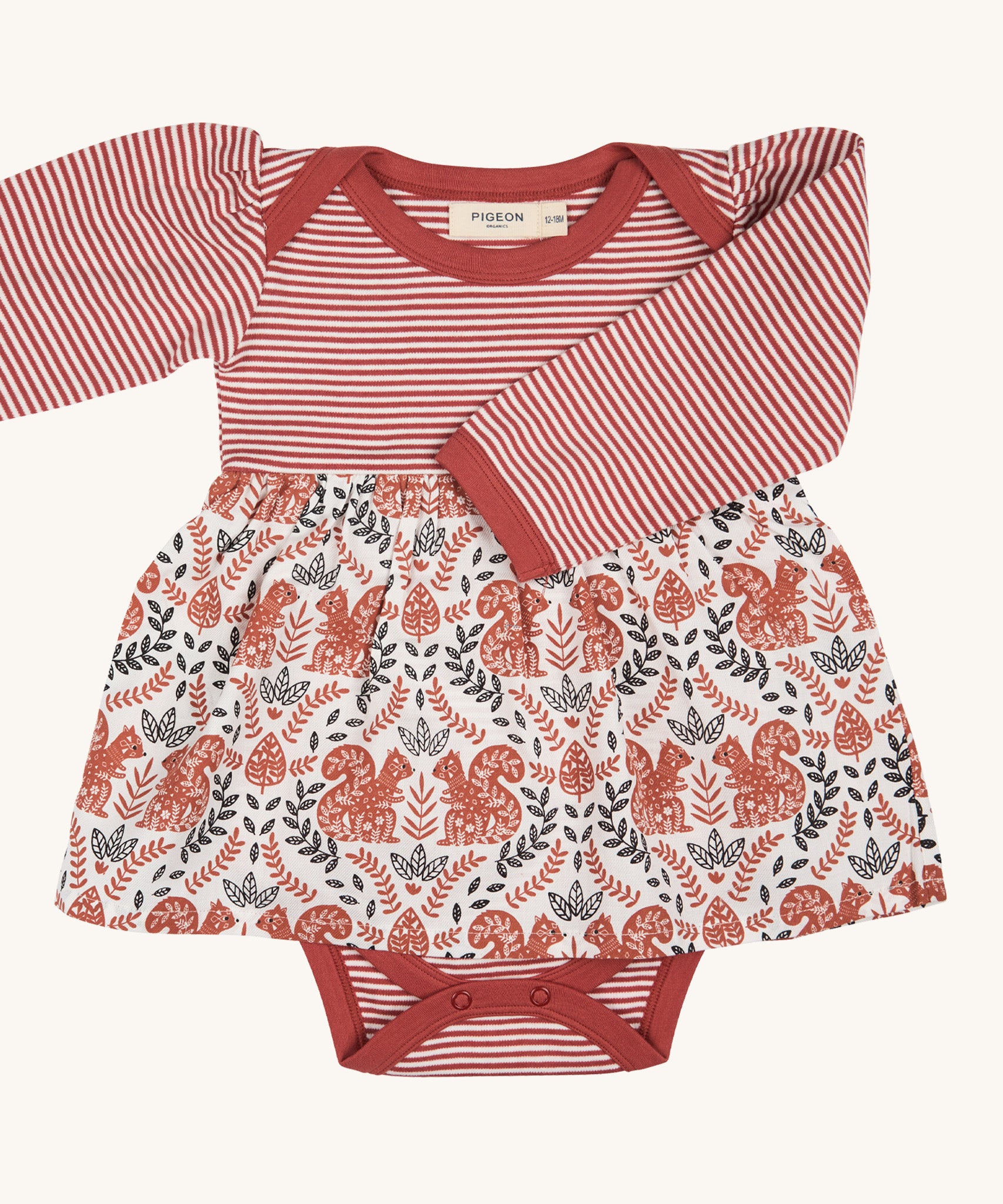 Pigeon Organics squirrel baby dress. A pale rust striped top and printed woven skirt on 100% GOTS organic cotton fabric. Features poppers at the crotch for easy changing.