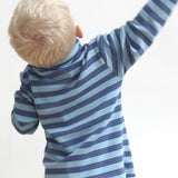 A child wearing the Pigeon Organics long sleeve top showing the blue striped detail on organic cotton fabric