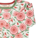 A close up of the pink floral Pigeon organics long sleeve top available at Babipur showing the popper fastener detail on the shoulder