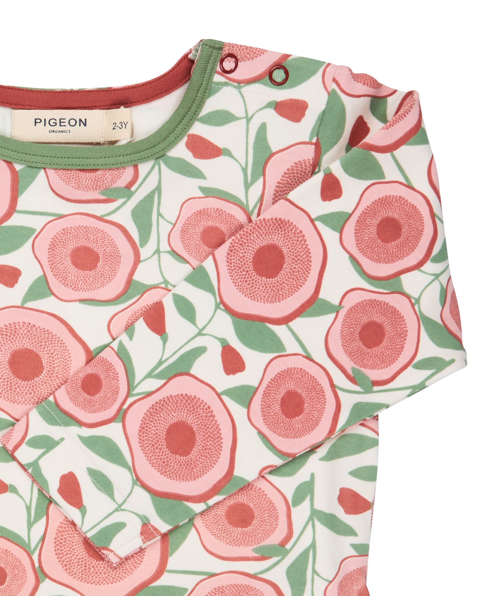 A close up of the pink floral Pigeon organics long sleeve top available at Babipur showing the popper fastener detail on the shoulder