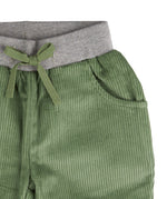 A close up of the Pigeon Organics lined cord trousers available at Babipur showing the grey elasticated waistband and green drawstring detail