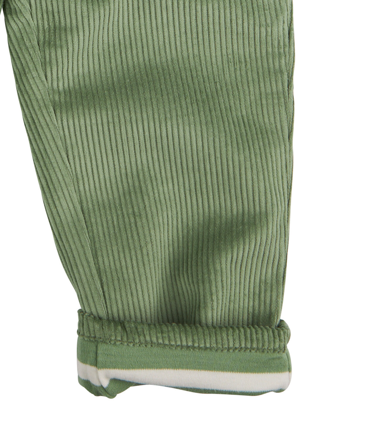 A close up of the Pigeon Organics lined cord trousers available at Babipur showing the green and white striped design on the inner liner 