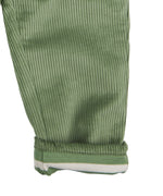 A close up of the Pigeon Organics lined cord trousers available at Babipur showing the green and white striped design on the inner liner 