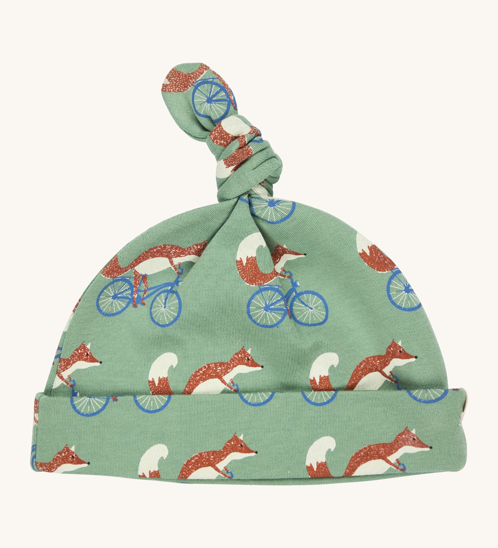 Pigeon Organics knotted baby hat - 100% GOTS organic pale green cotton hat with a top knot. Features multiple prints of a fox riding a blue bike.