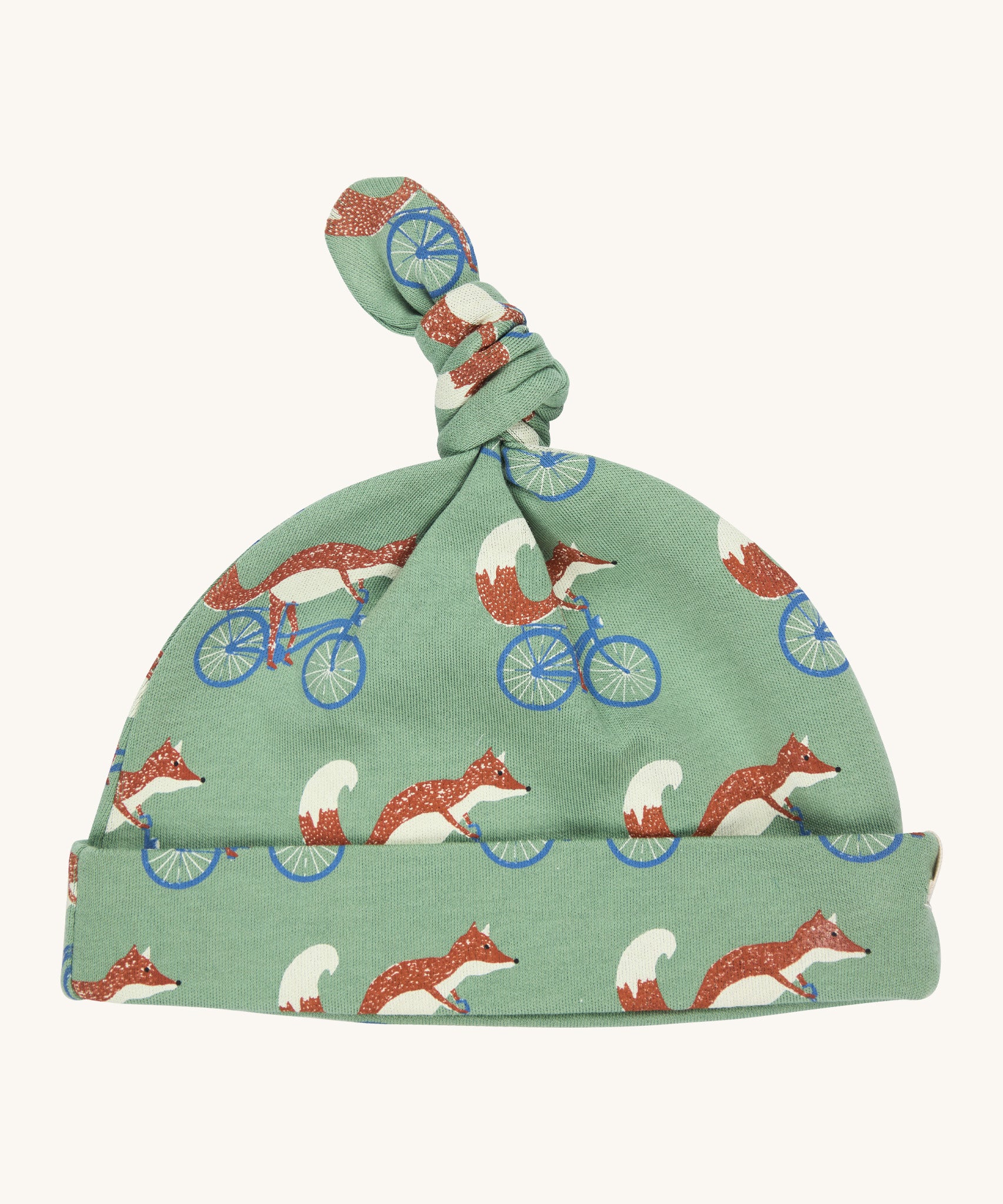 Pigeon Organics knotted baby hat - 100% GOTS organic pale green cotton hat with a top knot. Features multiple prints of a fox riding a blue bike.