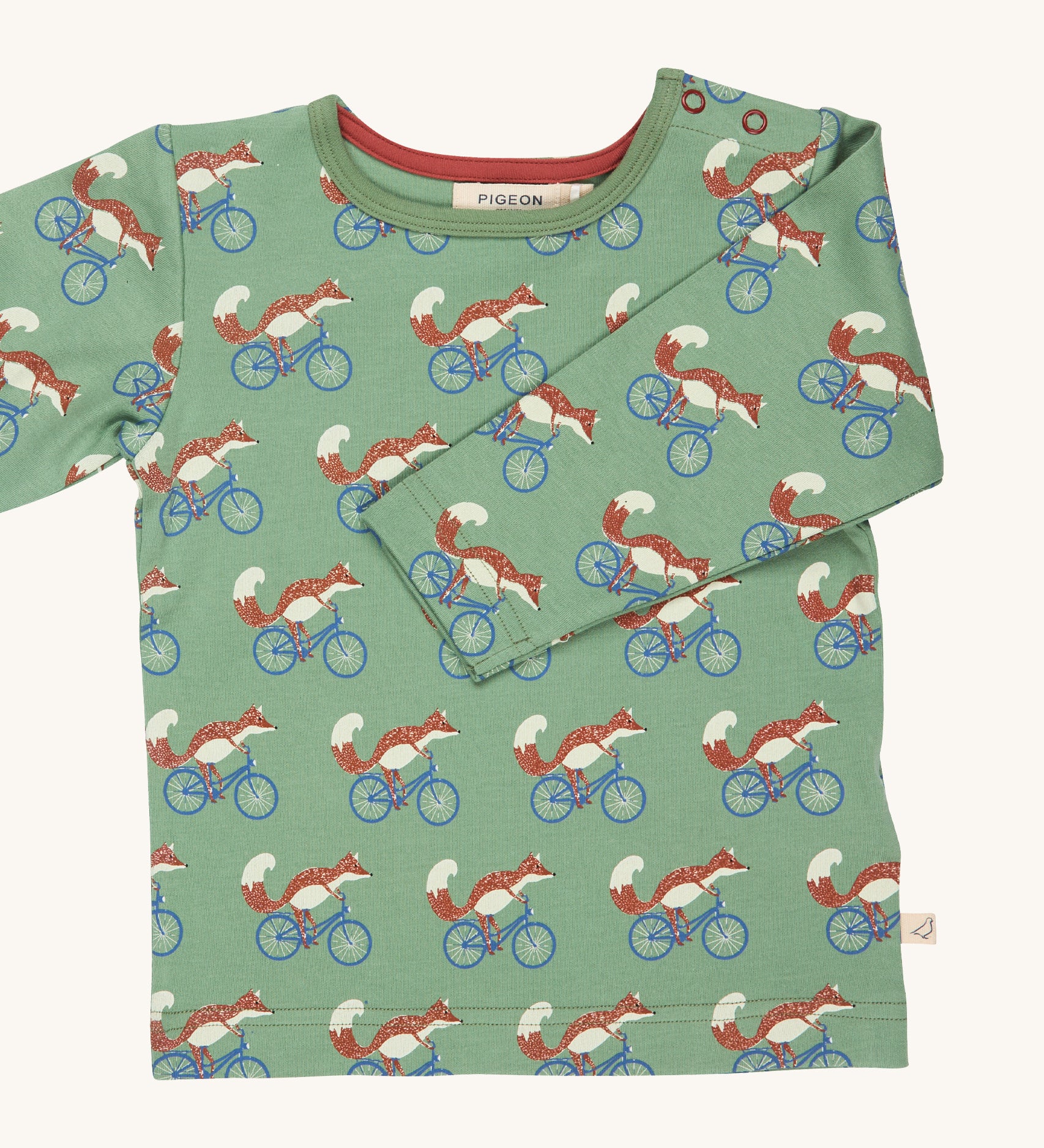 Pigeon Organics Green cycling fox t-shirt - GOTS organic cotton t-shirt with long sleeves. Features multiple prints of a fox riding a blue bike.
