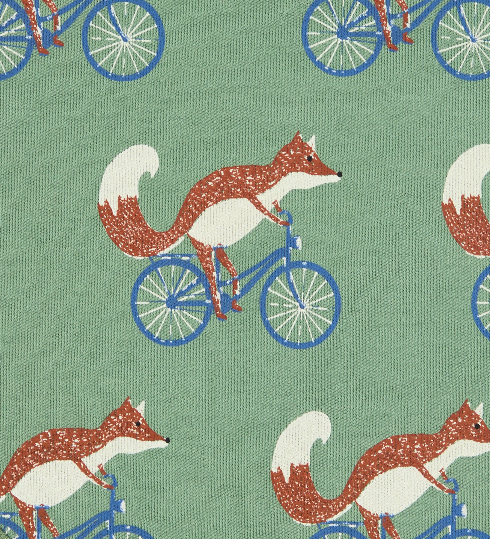 Close up of the Pigeon Organics cycling fox printed on organic green cotton fabric.