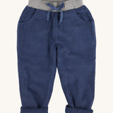Pigeon Organics linen cord trousers - GOTS midnight blue coloured organic cotton trousers in a corduroy style. Features 2 side pockets, a soft elastic waistband in grey and green drawstring detail at the front.
