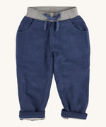 Pigeon Organics linen cord trousers - GOTS midnight blue coloured organic cotton trousers in a corduroy style. Features 2 side pockets, a soft elastic waistband in grey and green drawstring detail at the front.