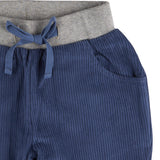 A close up of the Pigeon Organics lined cord trousers available at Babipur showing the grey elasticated waistband and drawstring detail