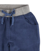 A close up of the Pigeon Organics lined cord trousers available at Babipur showing the grey elasticated waistband and drawstring detail