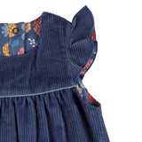 A close up of the corduroy detail on the Pigeon organics navy winter shift dress showing the frill detail available at Babipur